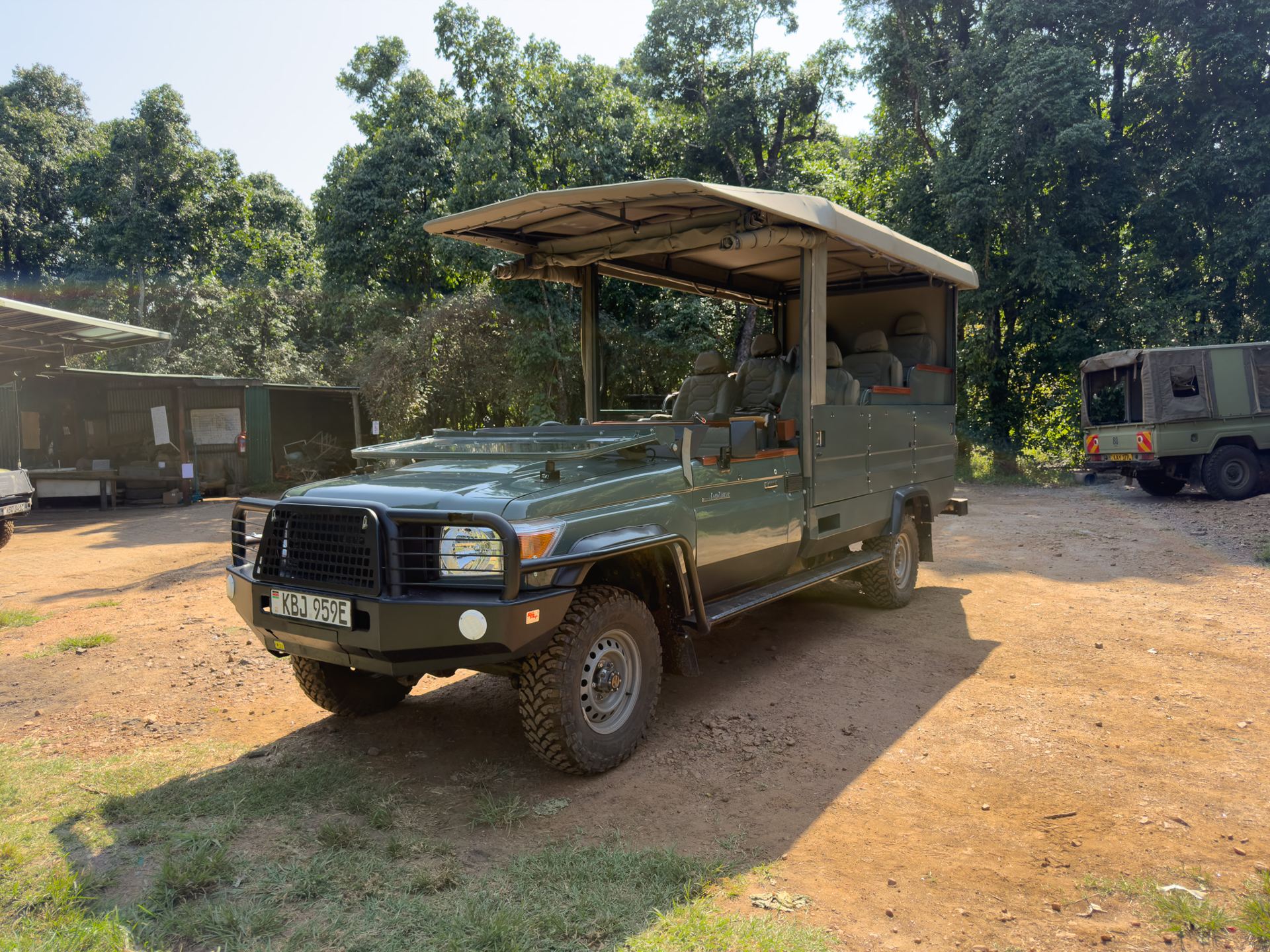 Electric Land Cruiser 79 game viewer conversion parked in the forest