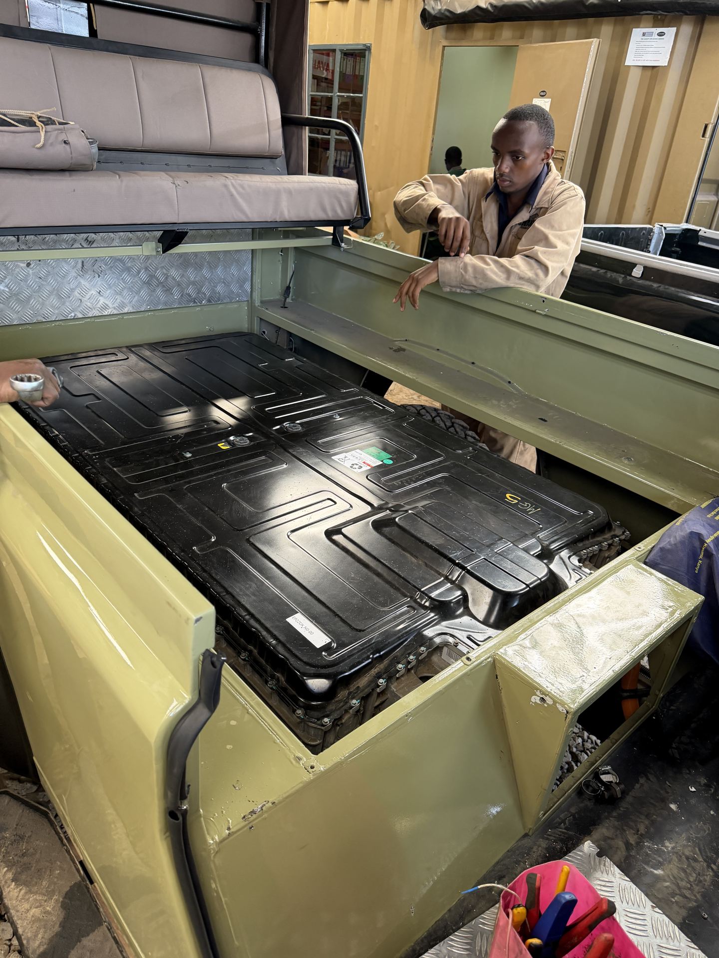 Battery pack being installed in a Land Rover Defender electric conversion